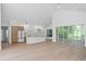 Bright living room with vaulted ceilings, hardwood floors, and a seamless open-concept design to the kitchen at 388 Hampton Hills Ct, Debary, FL 32713