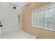 Luxurious walk-in shower featuring marble tiling, modern fixtures, and unique glass block window for natural light at 388 Hampton Hills Ct, Debary, FL 32713