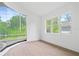 Bright sunroom with walls of windows overlooking lush greenery and hardwood flooring at 388 Hampton Hills Ct, Debary, FL 32713