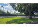 Outdoor tennis courts featuring black chain-link fencing and a green lawn at 388 Hampton Hills Ct, Debary, FL 32713