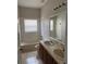 Bright bathroom featuring double sinks, tile flooring, and a shower/tub combo at 4034 Bougainvillea Pl, Kissimmee, FL 34746