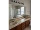 Bathroom showcasing double sinks, a soaking tub, and a separate glass-enclosed shower at 4034 Bougainvillea Pl, Kissimmee, FL 34746