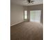 Bright bedroom with neutral carpet, large window, and a ceiling fan for added comfort at 4034 Bougainvillea Pl, Kissimmee, FL 34746