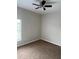 Bedroom featuring carpet floors, a ceiling fan, and natural light from the window at 4034 Bougainvillea Pl, Kissimmee, FL 34746