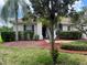 Inviting single-story home with lush landscaping, mulch beds, and a brick walkway at 4034 Bougainvillea Pl, Kissimmee, FL 34746