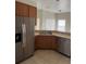 Kitchen with stainless steel appliances, wood cabinets, and a breakfast bar area at 4034 Bougainvillea Pl, Kissimmee, FL 34746