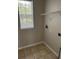 Compact laundry room with tile flooring, a window, and washer/dryer hookups at 4034 Bougainvillea Pl, Kissimmee, FL 34746