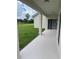 Outdoor patio space with a view of the backyard, pond and landscaping at 4034 Bougainvillea Pl, Kissimmee, FL 34746