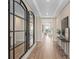 Bright hallway features modern wood floors, mirrors, decor, and trim details on the ceiling at 4116 Winding Pines Dr, Apopka, FL 32712