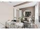Sitting area with a glass table, sofa, decorative beams and a circular mirror at 4116 Winding Pines Dr, Apopka, FL 32712