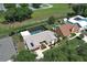 Aerial view of a home with pool, modern roof, stone accents, professional landscaping, and a private backyard at 414 Bonifay Ave, Orlando, FL 32825