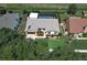 Aerial view showcasing a home with a fenced pool, landscaping, stone accents, and a new roof at 414 Bonifay Ave, Orlando, FL 32825