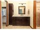 Bathroom with dark wood vanity, tile floor, neutral walls and walk-in shower at 414 Bonifay Ave, Orlando, FL 32825
