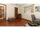 Bedroom with closet, window, wood floor, ottoman, and door to bathroom at 414 Bonifay Ave, Orlando, FL 32825