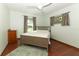 Bedroom has wood floor, ceiling fan, and two windows with curtains at 414 Bonifay Ave, Orlando, FL 32825
