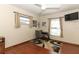 Bedroom with desk, TV, ceiling fan, and wood floor at 414 Bonifay Ave, Orlando, FL 32825