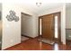 Inviting foyer features a decorative front door and hardwood flooring at 414 Bonifay Ave, Orlando, FL 32825