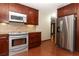 Updated kitchen features stainless steel appliances, granite countertops, tile backsplash, and wood cabinets at 414 Bonifay Ave, Orlando, FL 32825