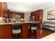 Stylish eat-in kitchen featuring dark wood cabinets, stainless appliances, and a breakfast bar at 414 Bonifay Ave, Orlando, FL 32825