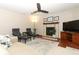 Inviting living room with a fireplace, comfortable seating, and a ceiling fan at 414 Bonifay Ave, Orlando, FL 32825