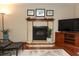 Comfortable living room features tile fireplace, ceiling fan, and a flat screen television at 414 Bonifay Ave, Orlando, FL 32825