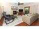 Bright living room with fireplace, ceiling fan, sliding glass doors to the lanai, and comfortable seating at 414 Bonifay Ave, Orlando, FL 32825