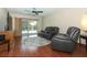 Comfortable living room with hardwood floors, sliding door to the pool, and a ceiling fan at 414 Bonifay Ave, Orlando, FL 32825
