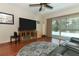 Cozy living room with a large TV, comfortable seating, and a sliding glass door to the pool area at 414 Bonifay Ave, Orlando, FL 32825