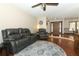 Inviting living room with hardwood floors, stylish furnishings, and a contemporary ceiling fan at 414 Bonifay Ave, Orlando, FL 32825