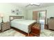 Serene main bedroom with a sliding glass door to the backyard and a comfortable king-size bed at 414 Bonifay Ave, Orlando, FL 32825