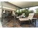 Relaxing screened-in patio with slate floor, furniture, and grill at 414 Bonifay Ave, Orlando, FL 32825