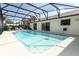 Screened-in pool area featuring a pristine pool, lounge chairs, and access to the home's sliding doors at 414 Bonifay Ave, Orlando, FL 32825