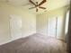 Bedroom featuring carpet, ceiling fan, and white doors at 4632 Egg Harbor Dr, Kissimmee, FL 34746