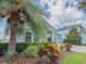 View of the home with stone accents, lush landscaping, and a three-car garage at 4632 Egg Harbor Dr, Kissimmee, FL 34746