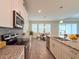 Modern kitchen featuring stainless steel appliances, granite countertops, and an open floor plan at 4632 Egg Harbor Dr, Kissimmee, FL 34746