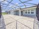 Screened-in back patio has brick pavers and ample space for entertaining guests at 4632 Egg Harbor Dr, Kissimmee, FL 34746