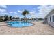 Community pool with brick surround and lush palm trees, and plenty of seating at 4632 Egg Harbor Dr, Kissimmee, FL 34746
