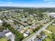 Aerial view showcasing the neighborhood with a pond and fountain near well-maintained Gathering residences at 470 Regal Downs Cir, Winter Garden, FL 34787