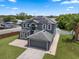 An aerial view of the home with solar panels, a gray exterior, and a well-manicured lawn at 470 Regal Downs Cir, Winter Garden, FL 34787