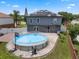 Aerial view of backyard featuring a pool, patio, and lush landscaping around the home at 470 Regal Downs Cir, Winter Garden, FL 34787