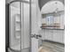 Bright bathroom featuring a stand up shower and a modern kitchen with white cabinets in the background at 470 Regal Downs Cir, Winter Garden, FL 34787