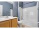 Well-lit bathroom with wood vanity, commode, and tub-shower combo, creating a clean and functional space at 470 Regal Downs Cir, Winter Garden, FL 34787