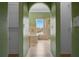 Beige tiled bathroom featuring a large bathtub and glass-enclosed shower with a view from the arched opening at 470 Regal Downs Cir, Winter Garden, FL 34787