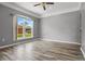 Spacious bedroom with natural light, wood-look floors, and neutral paint at 470 Regal Downs Cir, Winter Garden, FL 34787