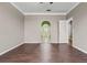 Inviting bedroom with hardwood floors, an archway entry and a view into a bathroom at 470 Regal Downs Cir, Winter Garden, FL 34787
