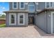 Close-up of an attractive two-story home featuring a paver driveway and attractive front door at 470 Regal Downs Cir, Winter Garden, FL 34787