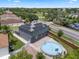 Charming house featuring solar panels, a backyard pool and a red brick patio area for outdoor enjoyment at 470 Regal Downs Cir, Winter Garden, FL 34787
