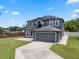 Beautiful two-story house featuring a spacious driveway, well-maintained landscaping, and neutral exterior paint at 470 Regal Downs Cir, Winter Garden, FL 34787