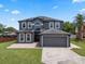 Beautiful two-story home with a spacious driveway, solar panels, and well-maintained landscaping at 470 Regal Downs Cir, Winter Garden, FL 34787