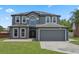 Charming two-story home with a spacious driveway, well-maintained lawn, and welcoming front entrance at 470 Regal Downs Cir, Winter Garden, FL 34787